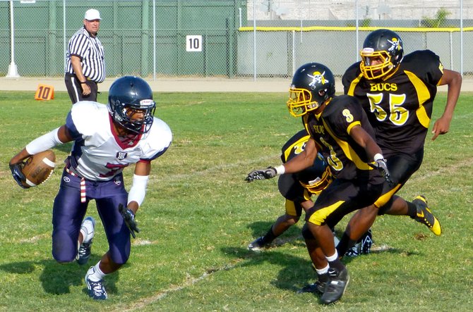 Horizon senior receiver Darren Carrington takes off outside with two Mission Bay defenders in pursuit