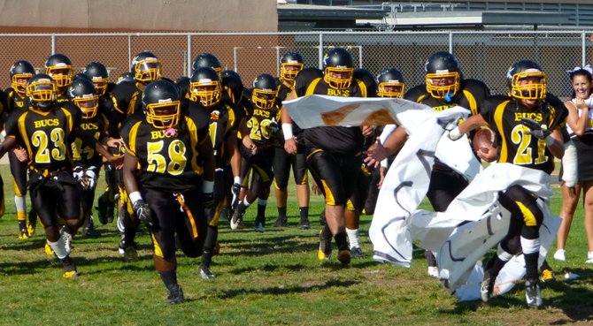 Mission Bay players break through the banner after halftime