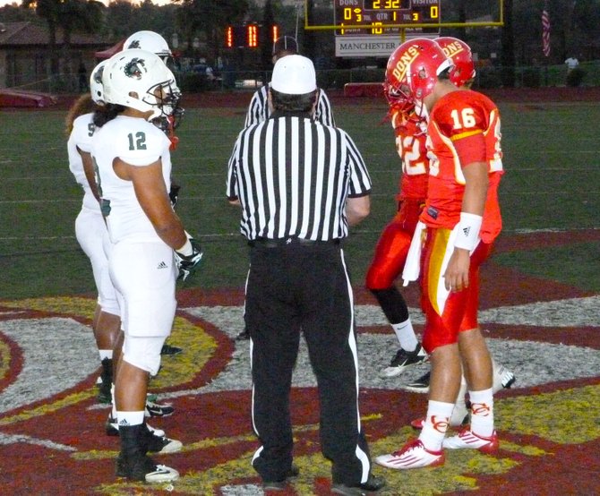 Helix and Cathedral Catholic captains meet in the middle of the field for the coin toss
