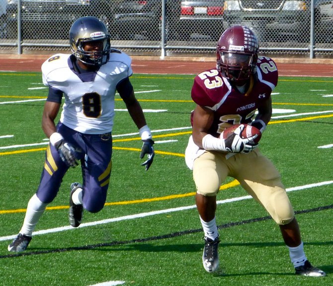 Point Loma senior running back Jamal Agnew hauls in a pass in front of Morse junior defensive back Justin Hutsona