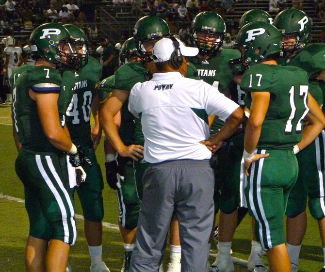 Poway huddles up around head coach Damian Gonzalez during a timeout
