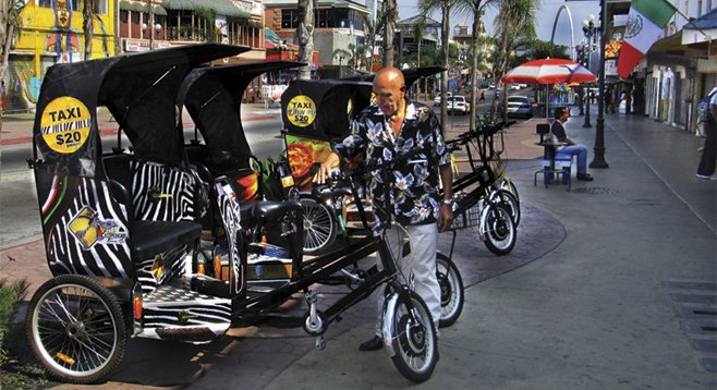 “Pedicabista” Hector inspects his pedicab before heading to his route.  The zebra stripes and logo pay homage to Tijuana’s infamous “Zonkeys.”  