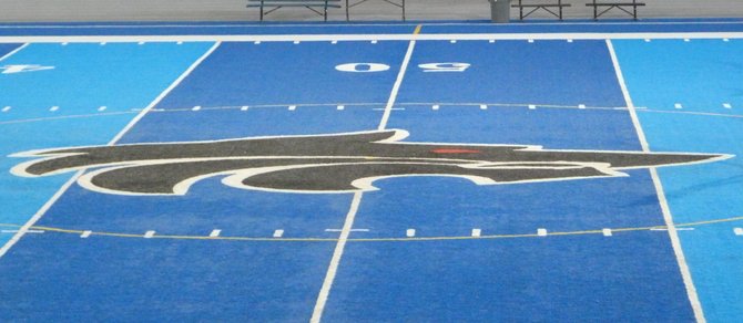 One of the few non-blue parts of the field at West Hills is the midfield logo, a black wolf head with a red eye