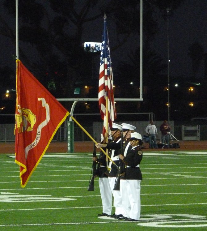 Members of Oceanside High's Marine Corps Jr. ROTC program present the flag for the national anthem