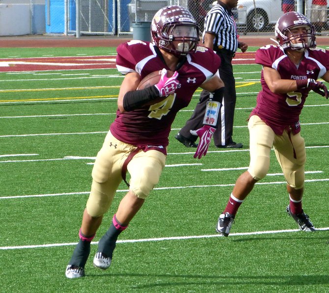 Point Loma junior running back A.J. Smith runs the ball outside