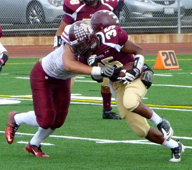 Point Loma senior running back Jamal Agnew fights through the tackle attempt of a Kearny defender