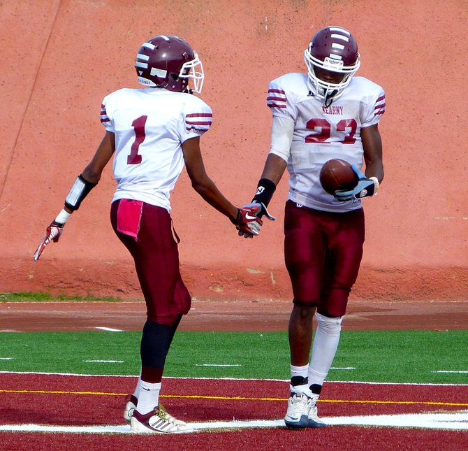Kearny senior receiver Quincey Burnell (1) and senior receiver Michael Green exchange a high five after a Green touchdown reception