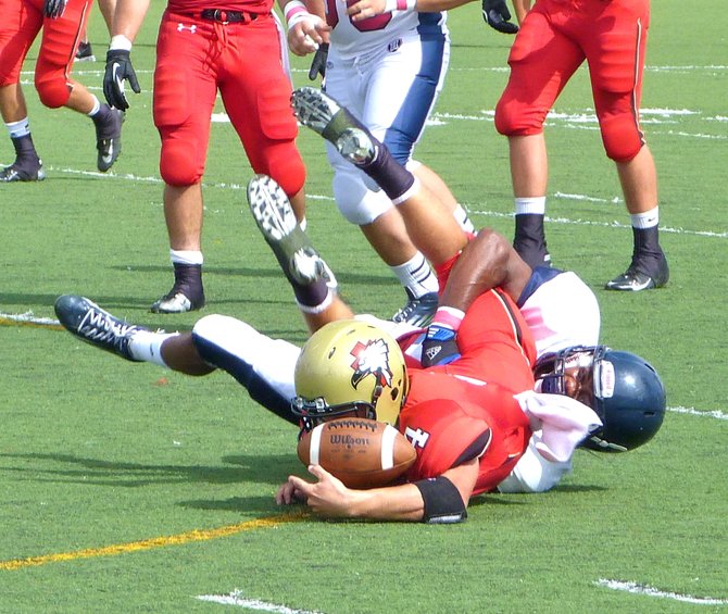 Santa Fe Christian senior quarterback Hunter Vaccaro loses the ball on the ground with a Horizon defender latched on