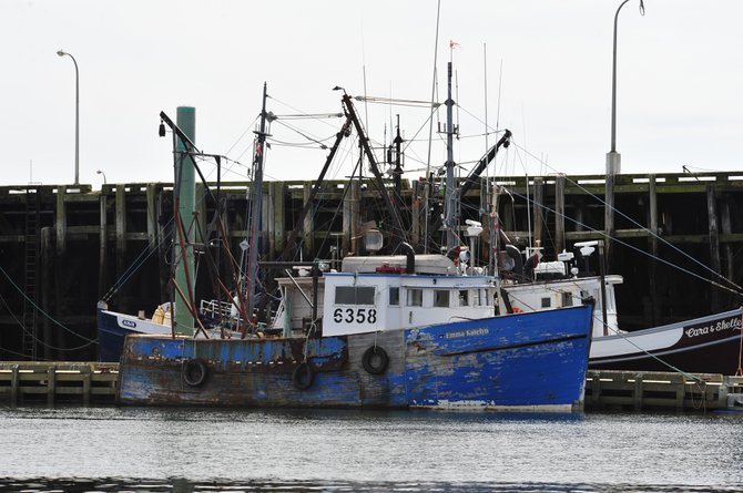 Nova Scotia, Canada.   The town of Digby and one of her 50+ scallop boats.   The tide will rise the boat so that her deck is even with the wharf.   This picture is at half tide.  Most of the fishermen name their boats after their children.