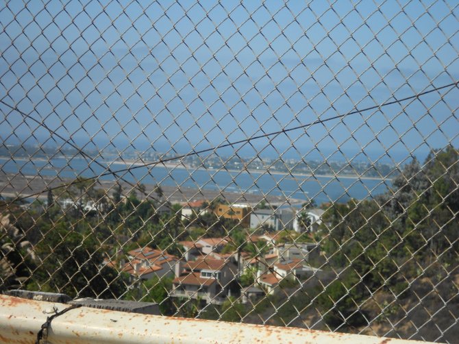 Overlooking Mission Bay through a fence on Clairemont Ave.