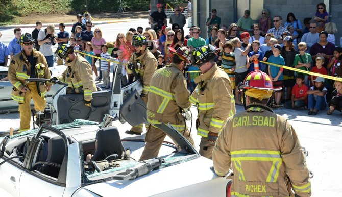 Firefighters swarmed a crushed car.  Photo Weatherston