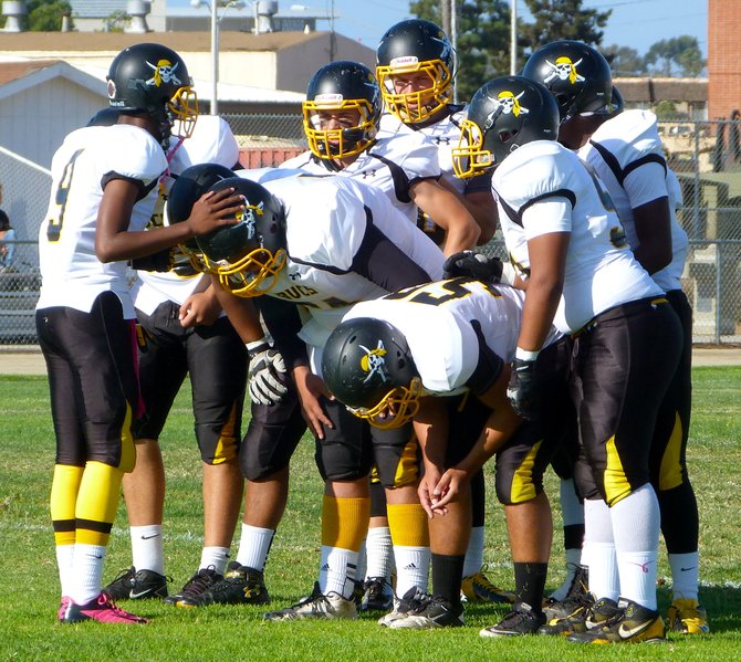 Mission Bay sophomore quarterback Devon Johnson calls out the play in the offensive huddle