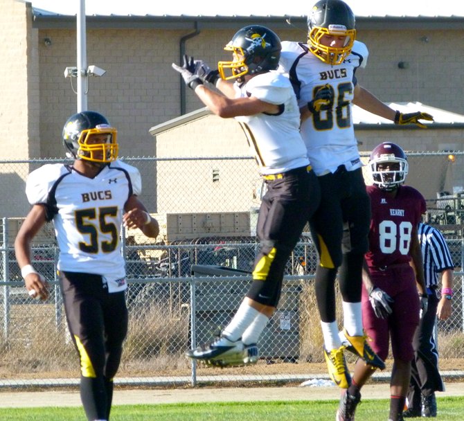 Mission Bay seniors receivers Kyle Plum (left) and Kelly Weese celebrate a Buccaneers touchdown with a side jump