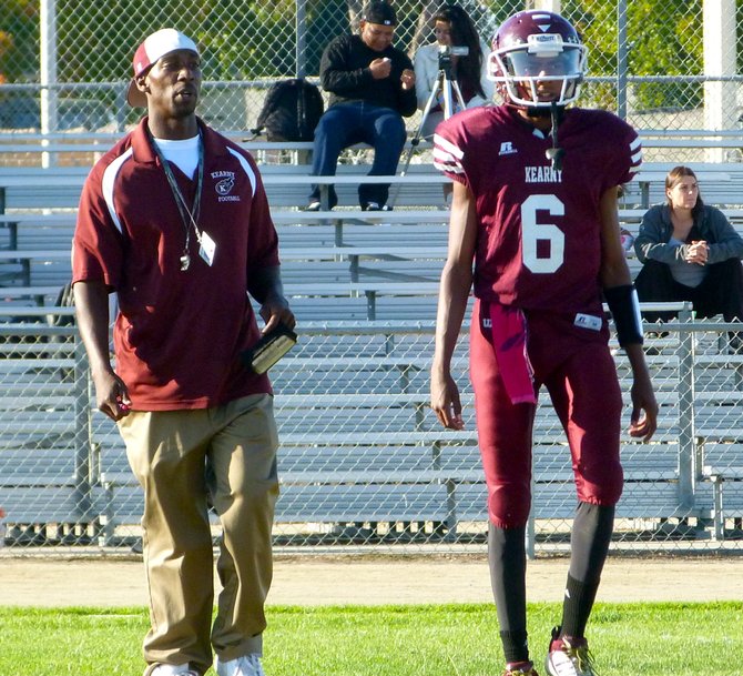 Kearny head coach Kenny Nears and sophomore quarterback Anfernee Hamilton survey the field