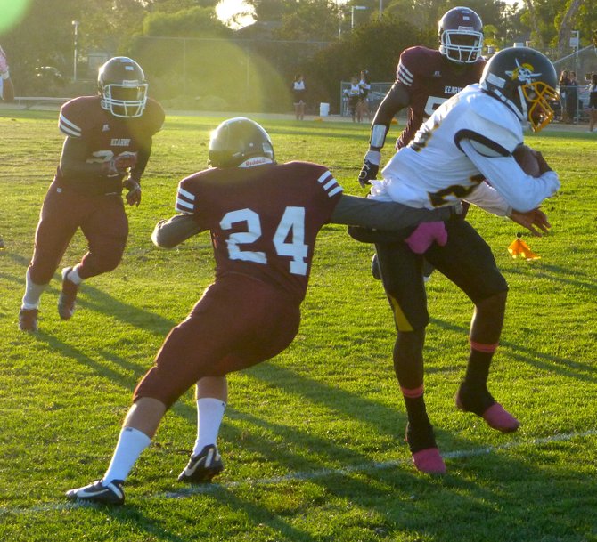Mission Bay junior receiver Airric Parker fights through the tackle attempt of Kearny defensive back Abel Tsegai