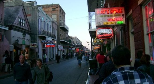 The bars of Bourbon Street aglow at dusk. 