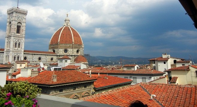 A red-rooftop view of Florence with the giant dome of Il Duomo cathedral.