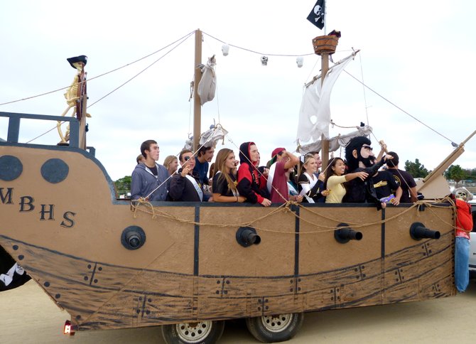Students roll down the track in a pirate ship during Mission Bay's Homecoming halftime show