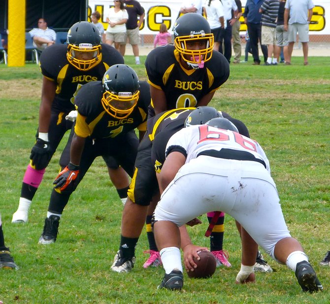 Mission Bay sophomore quarterback Devon Johnson under center with the Buccaneers lined up in the I formation