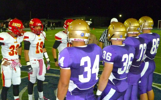 Cathedral Catholic and St. Augustine captains meet at midfield for the coin toss