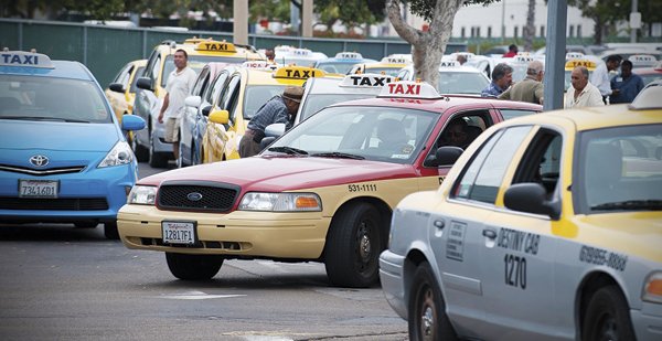 Taxis queue up at a holding lot near Lindbergh Field.
