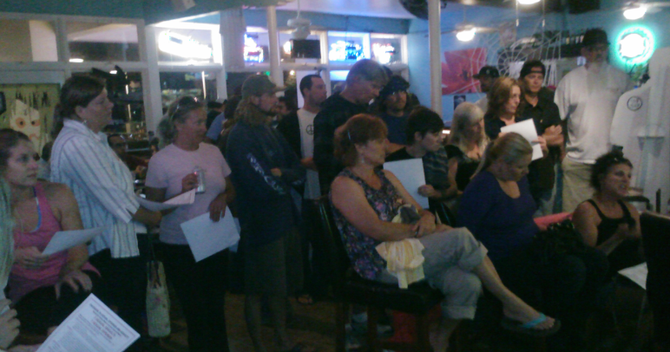 A rapt crowd listened to the victim tell her story at Tower Two Café.