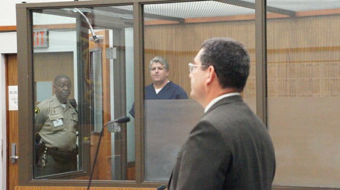 Pines in the holding tank, prosecutor James Romo in foreground. Photo Weatherston