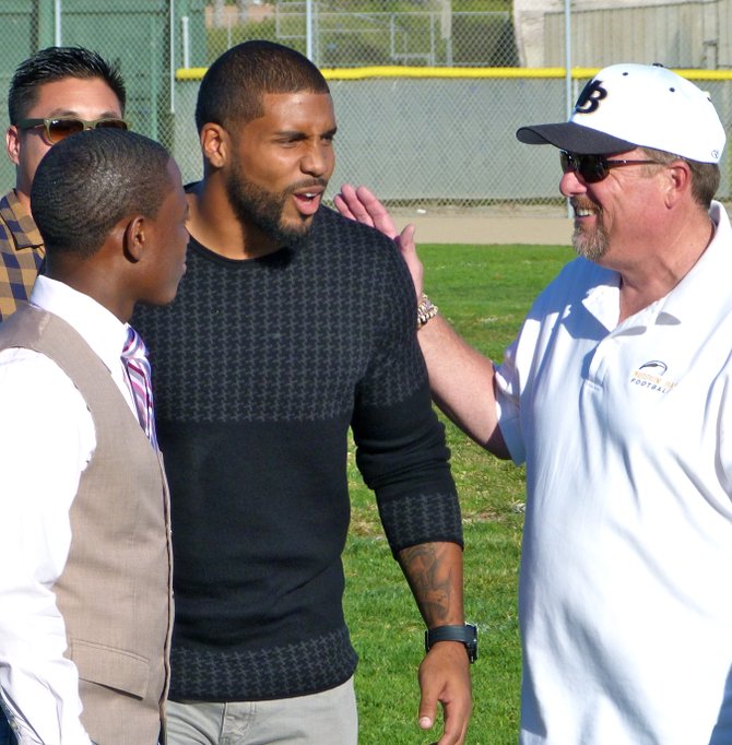 Houston Texans running back Arian Foster has a light moment with Mission Bay principal Fred Hilgers (left) during the ceremony