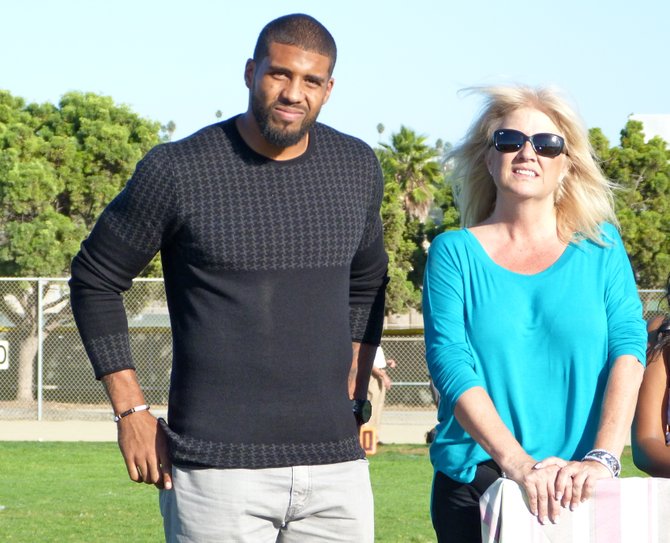 Houston Texans running back Arian Foster stands alongside Kathy Agosto, who was his mentor at Mission Bay High