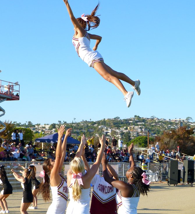 A Point Loma cheerleader takes flight to pump up the Pointers' faithful