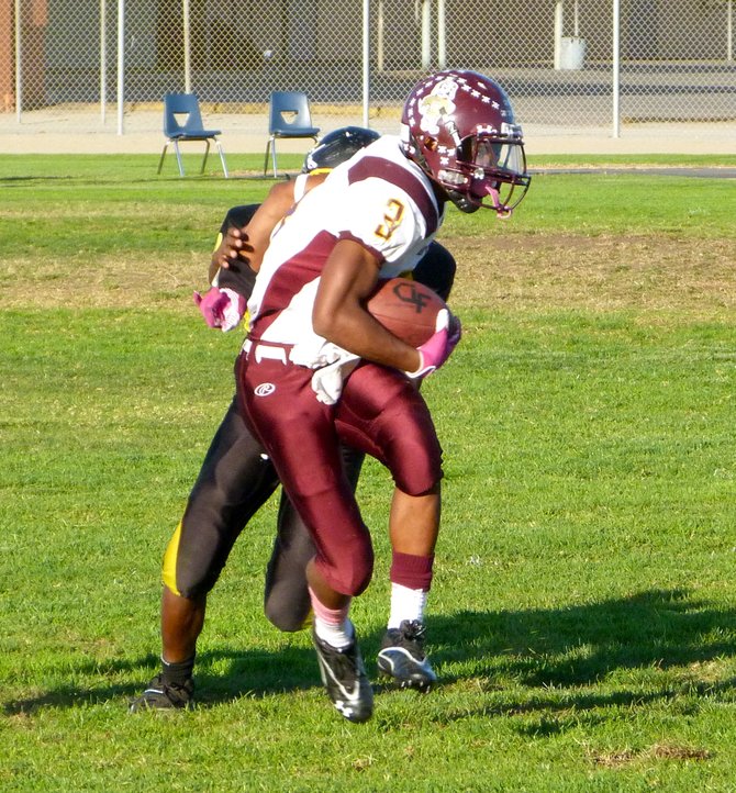 Point Loma junior running back D.J. Lacy runs the ball with a Mission Bay defender on his back