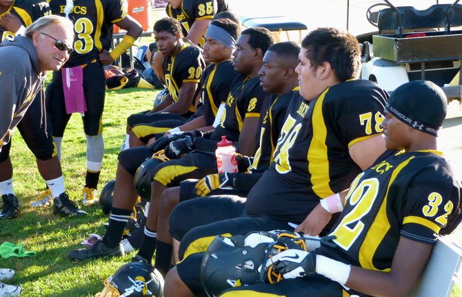 Mission Bay defensive coordinator Mel Galli talks to the Buccaneers defense on the sidelines