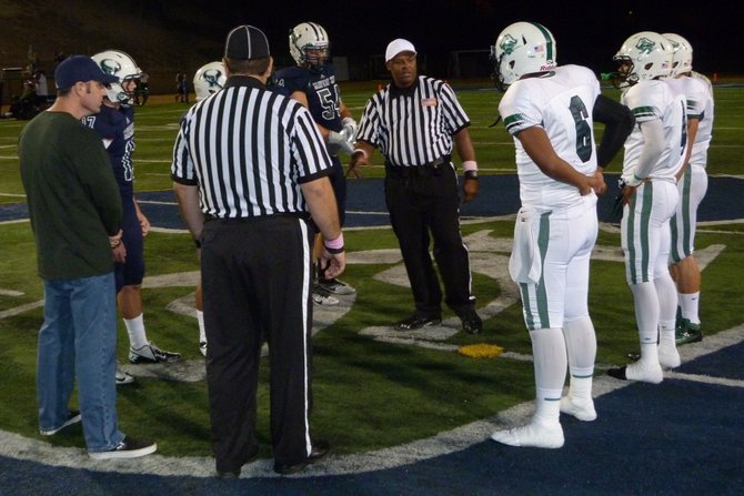 La Costa Canyon and Oceanside team captains meet at midfield for the coin toss