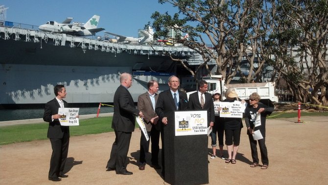 San Diego Tax Fighters' Richard Rider at the podium, with San Diego County Republican Party chair Tony Krvaric, Howard Jarvis Taxpayers Association's Jon Coupal, and other Prop 30 opponents