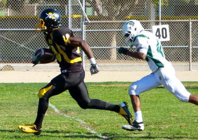 Mission Bay junior receiver Andre Petties-Wilson races past Coronado senior defensive back Tyree Johnson for a touchdown reception