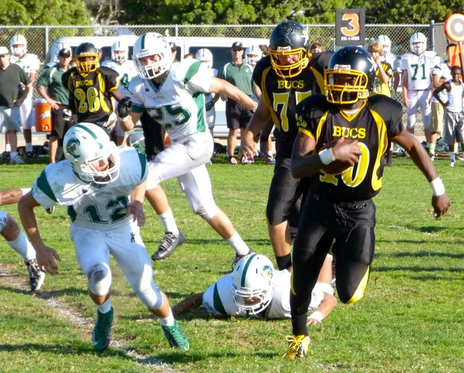 Mission Bay junior receiver Andre Petties-Wilson heads outside to elude Coronado junior defensive back Troy Lindell