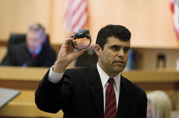  Prosecutor Pat Espinoza holds up the GPS ankle bracelet Stutzman cut off and threw out the car window.