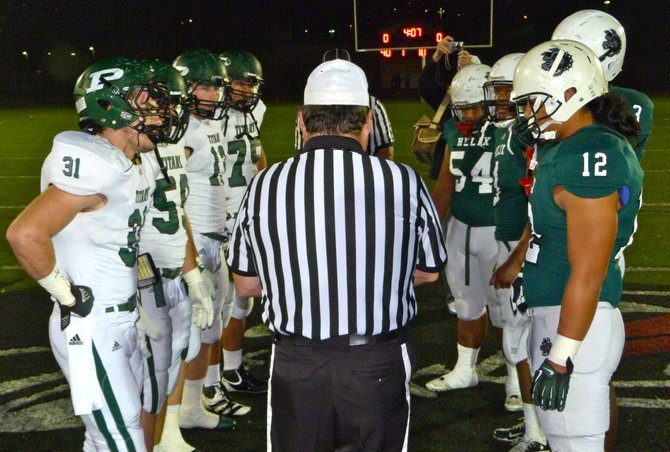 Poway and Helix team captains meet at midfield for the coin toss prior to the Division II semifinals