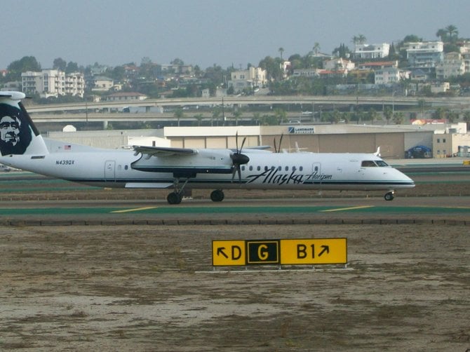 Horizon Air / Alaska Airlines turbo pulls over to watch Dreamliner arrival at downtown Airport.