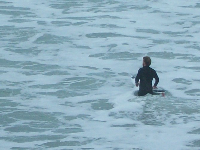 A surfer going on in Ocean Beach when the waves were huge!