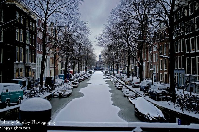 A Frozen Snowy Canal In Amsterdam
