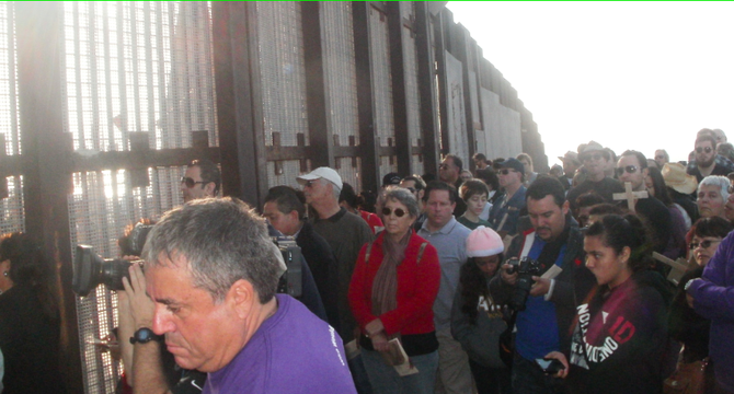 Border Patrol agents opened the gate to let hundreds of people stand with dozens more on the Mexico side of the fence.