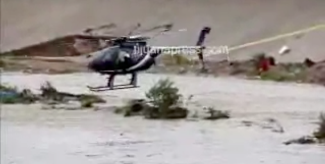A helicopter finally rescued the couple from the middle of the canal (image from Tijuana Press video)