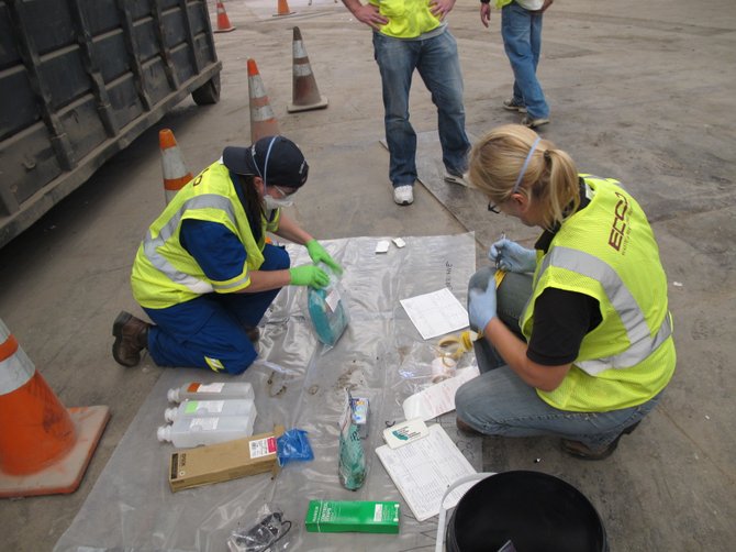 San Diego Department of Environmental Health, District Attorney and City Attorney investigators examine the contents of a Walgreens dumpster in North Park. Photo courtesy District Attorney's office.