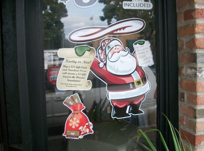 Santa flips pizza dough at Knockout Pizza, located on Carlsbad Boulevard (Carlsbad’s name for Coast Hwy.)