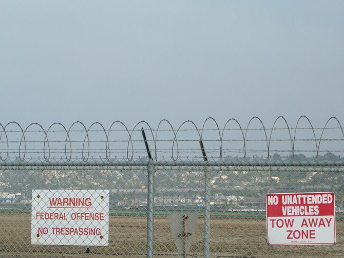 Unfriendly signs along the perimeter fence of the SD Int'l Airport.