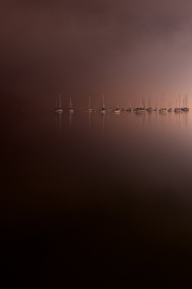 Nighttime fog on San Diego Bay creates a sense of limbo between water and sky.