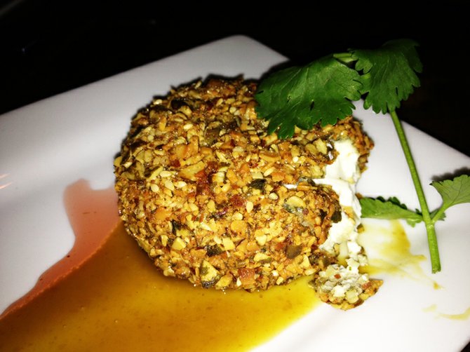 Pepita- and almond-crusted goat cheese with chipotle syrup and jamaica reduction