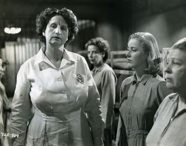 Babe-behind-bars Eleanore Parker (R) is no match for 6' 2", 230 pound prison matron Hope Emerson in "Caged" (1950). 