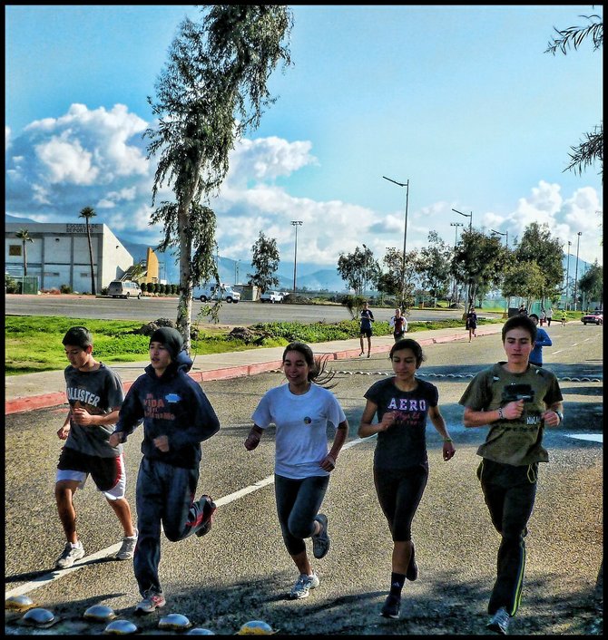 ATHLETES RUNNING OUTSIDE SPORTS TRAINING CENTER IN TIJUANA/Atletas corriendo afauera de Centro de Atlo Rendimiento en Tijuana.